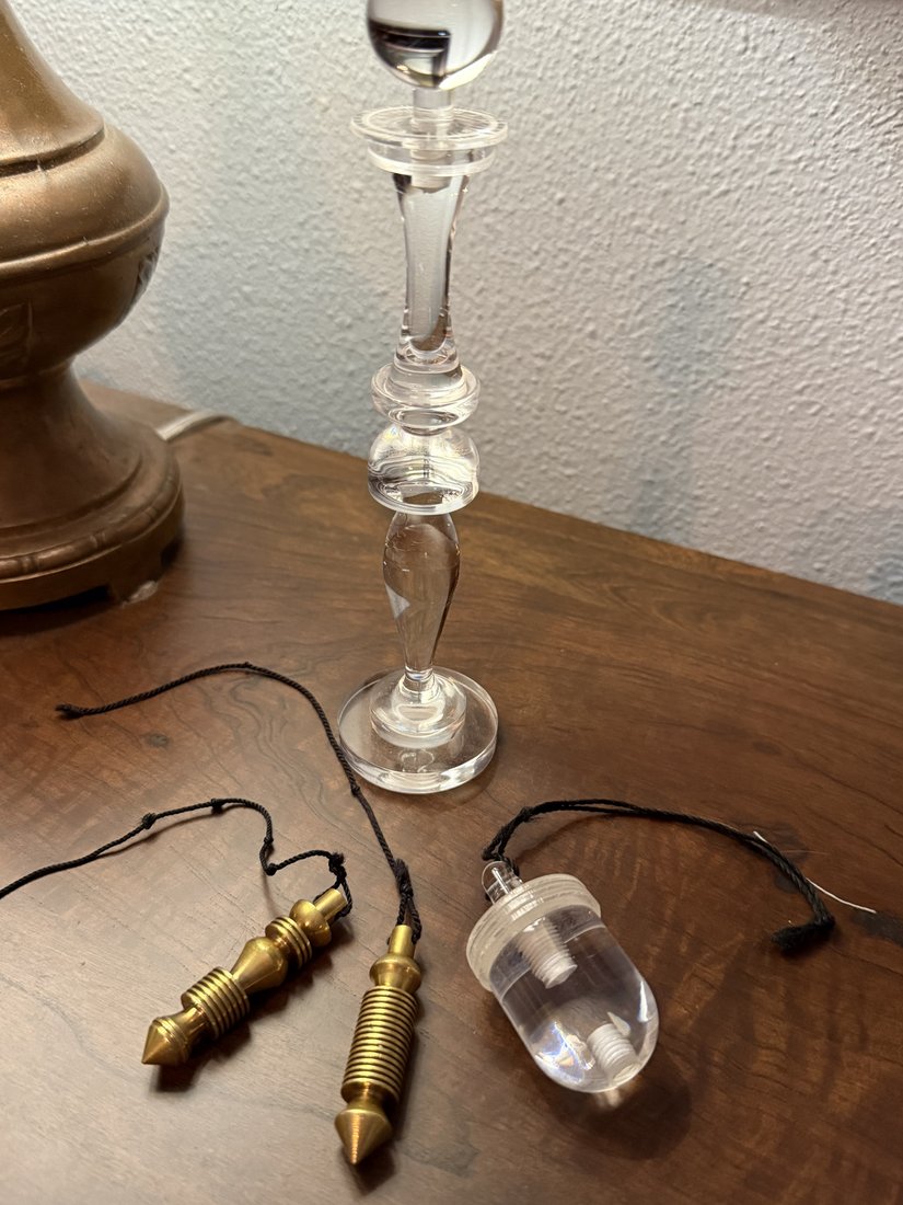 Bobby's dowsing and measurement instruments laid out on a wood table